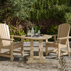 Outdoor patio set with round table and chairs on a stone patio.
