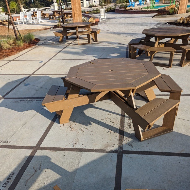 Octagonal picnic table with benches on a concrete surface