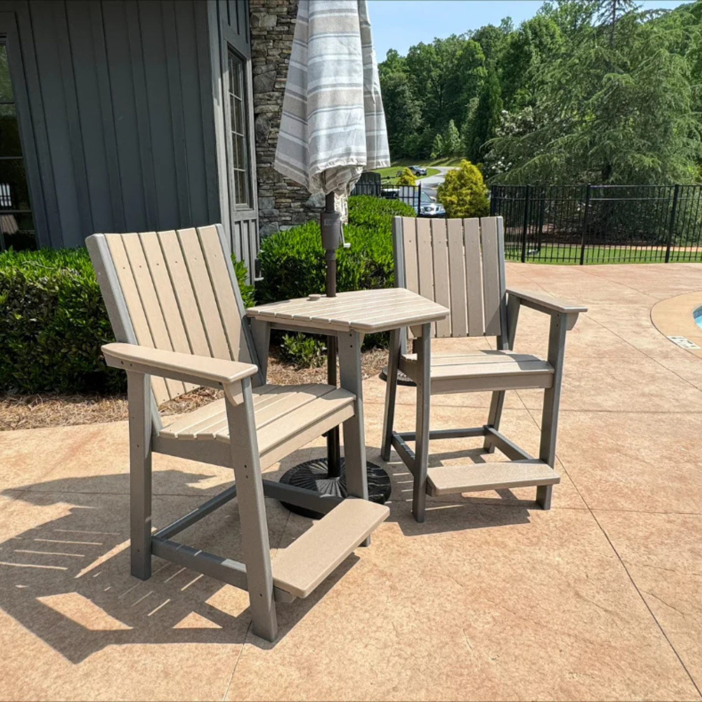 Two SoPoly Callaway counter chairs with connector table as well as umbrella 